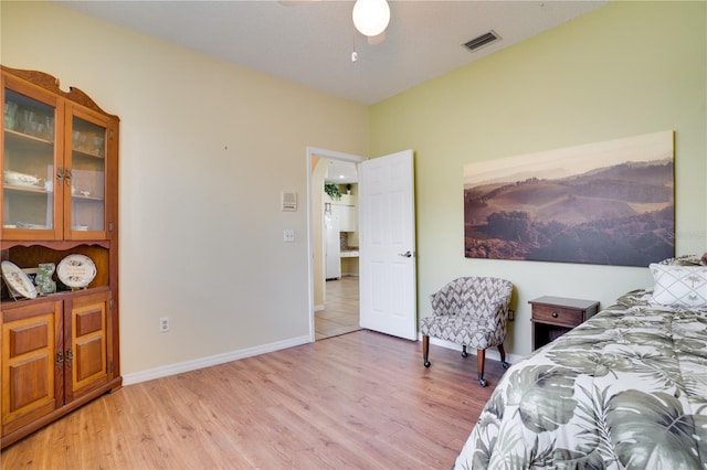 bedroom with light hardwood / wood-style flooring and ceiling fan