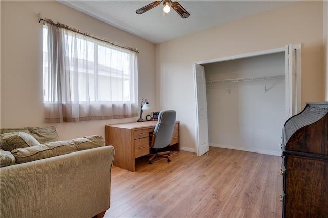 office area with ceiling fan, light hardwood / wood-style flooring, and a textured ceiling