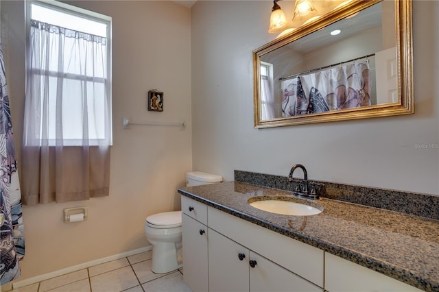 bathroom featuring tile patterned floors, vanity, and toilet