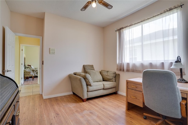 office space with ceiling fan and light hardwood / wood-style flooring