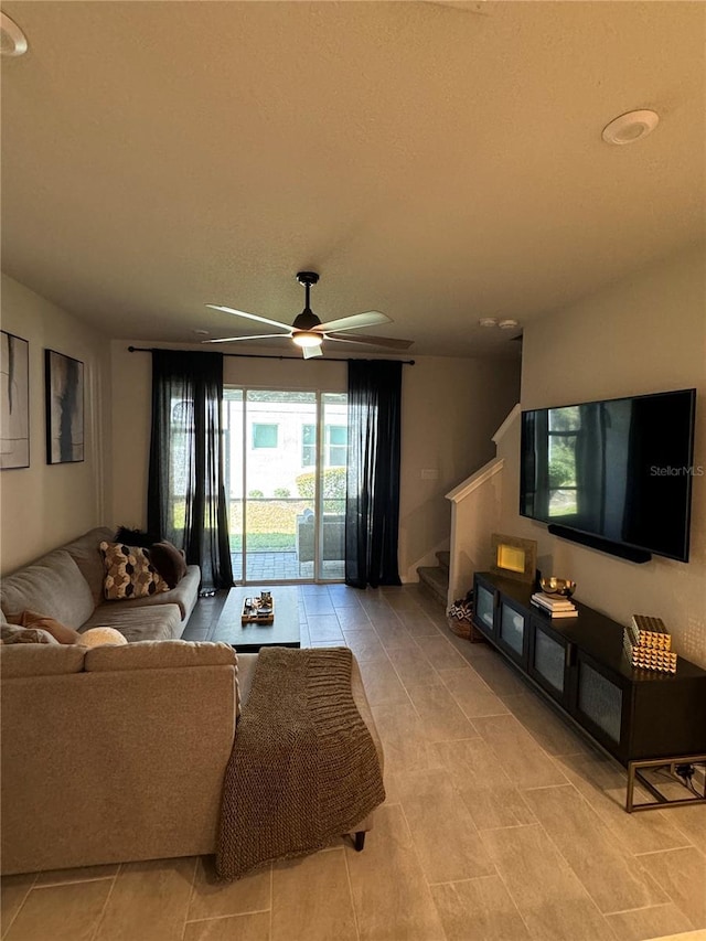 tiled living room featuring ceiling fan