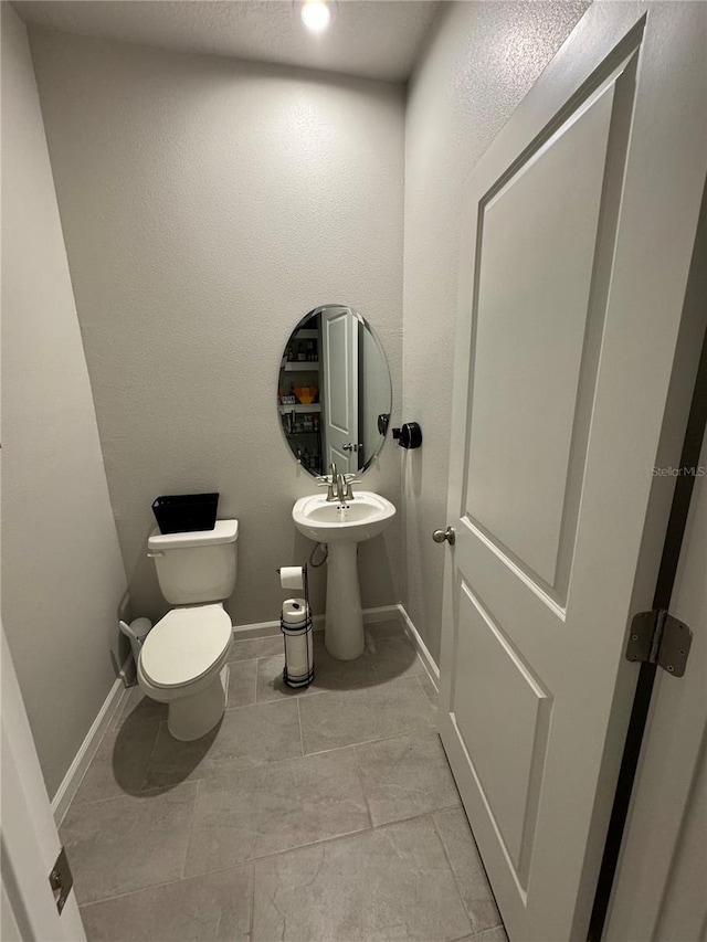 bathroom with tile patterned floors and toilet