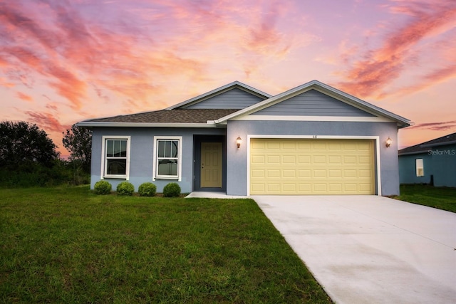 view of front of house featuring a yard and a garage