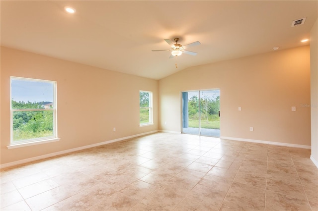 spare room featuring ceiling fan, light tile patterned floors, and lofted ceiling