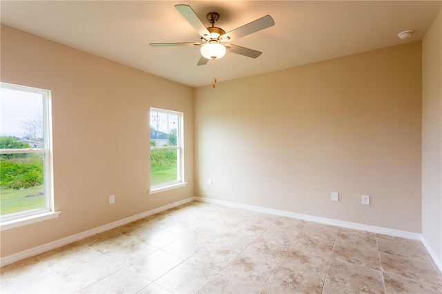 unfurnished room featuring ceiling fan, light tile patterned floors, and a wealth of natural light