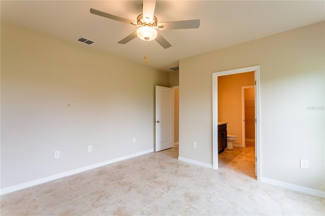 unfurnished bedroom with connected bathroom, ceiling fan, and light tile patterned flooring