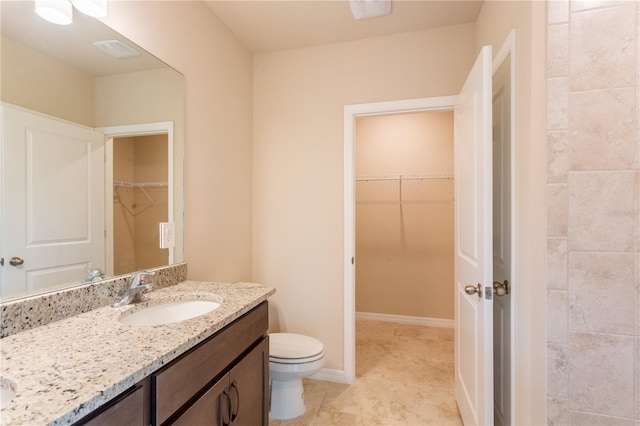 bathroom featuring tile patterned flooring, vanity, and toilet