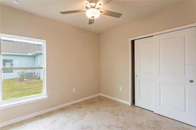 unfurnished bedroom with ceiling fan, light tile patterned floors, and a closet