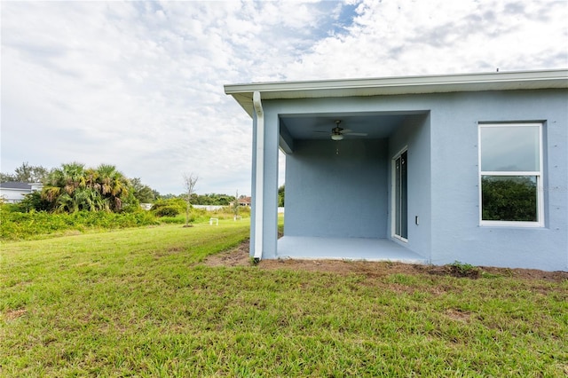 rear view of property featuring a yard and a patio