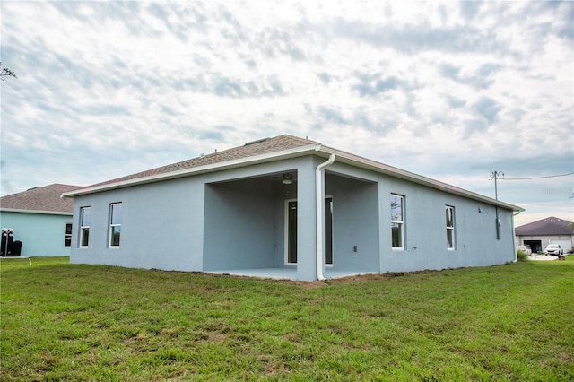 rear view of house with a lawn and a patio area