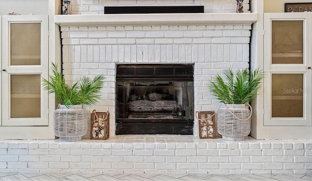 interior details with a brick fireplace