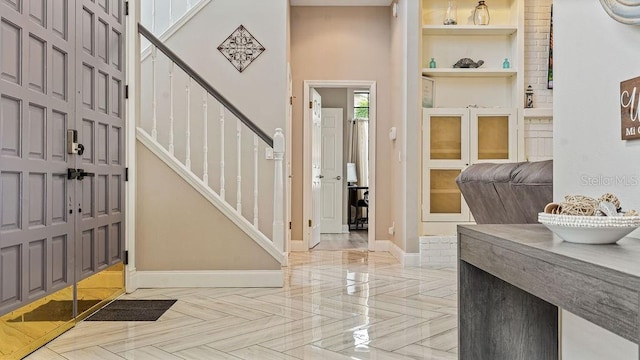 foyer entrance featuring parquet flooring