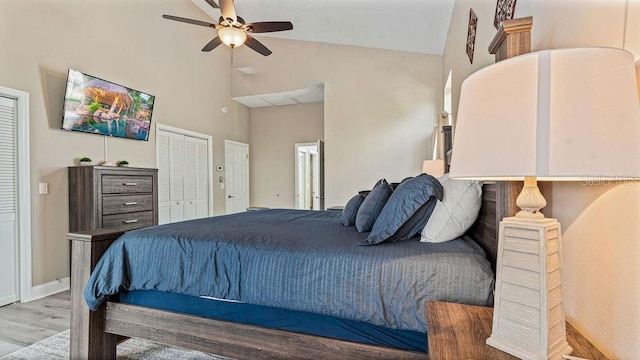 bedroom with high vaulted ceiling, light hardwood / wood-style flooring, and ceiling fan