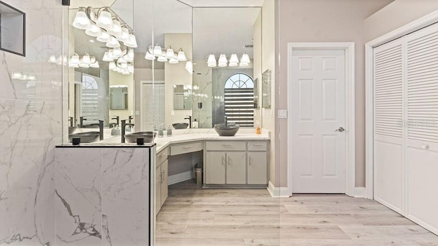 bathroom with a shower, hardwood / wood-style floors, and vanity