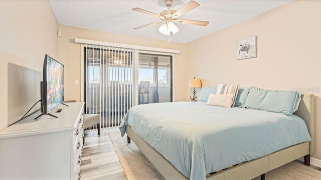 bedroom with access to exterior, light hardwood / wood-style flooring, and ceiling fan