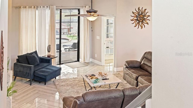 living room featuring ceiling fan and light parquet floors