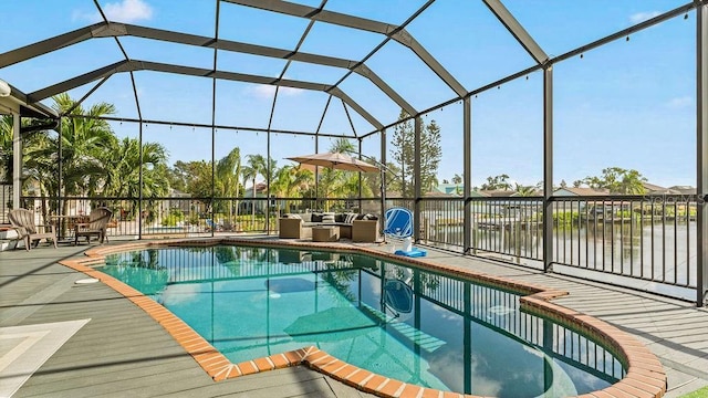 view of pool with a lanai, a water view, and a patio