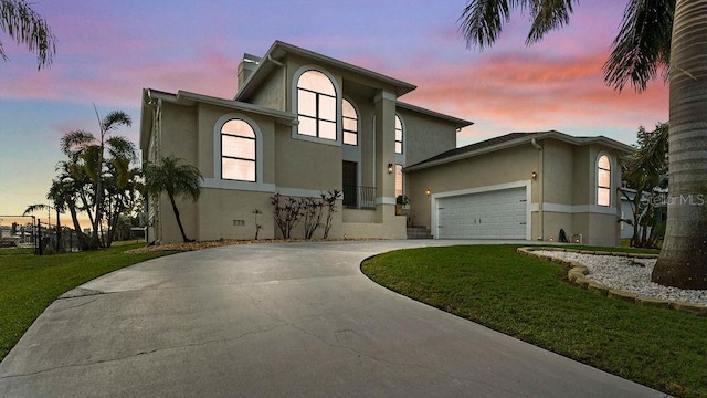 view of front of home with a lawn and a garage