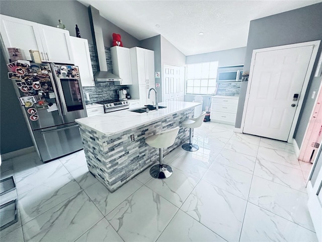 kitchen featuring sink, white cabinets, a center island with sink, and appliances with stainless steel finishes