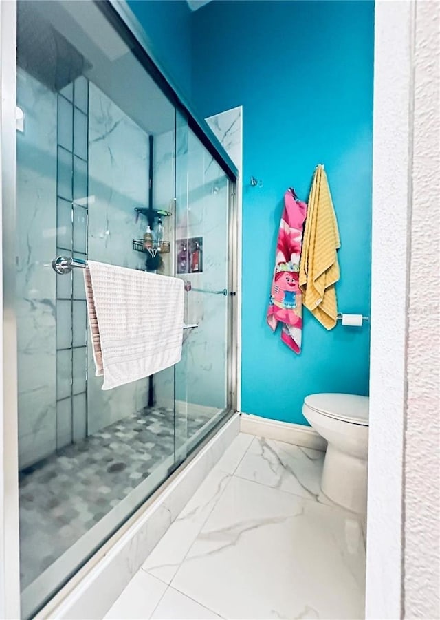 bathroom featuring toilet and an enclosed shower