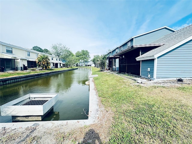 view of dock featuring a yard and a water view