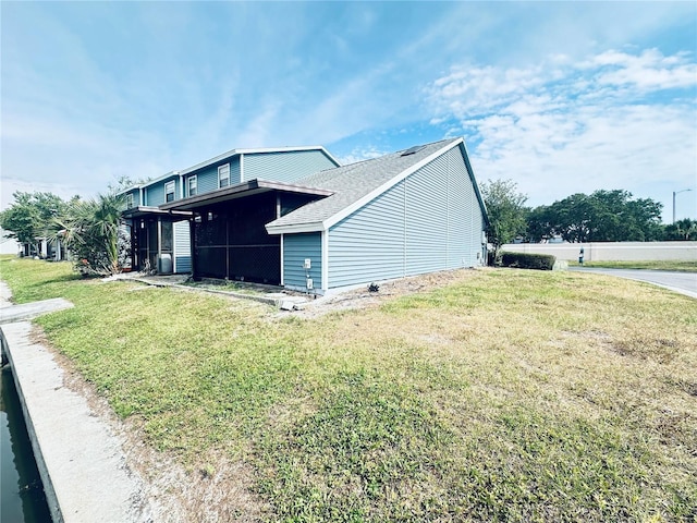 view of side of home featuring a lawn