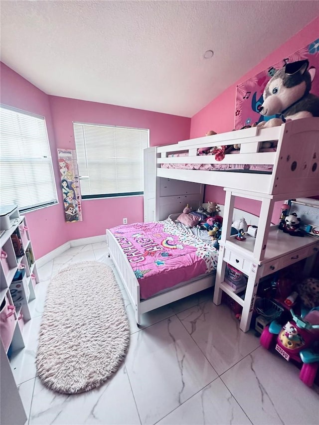 bedroom featuring lofted ceiling and a textured ceiling