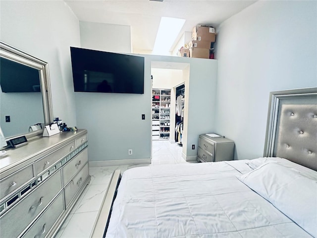 bedroom with a spacious closet and a closet