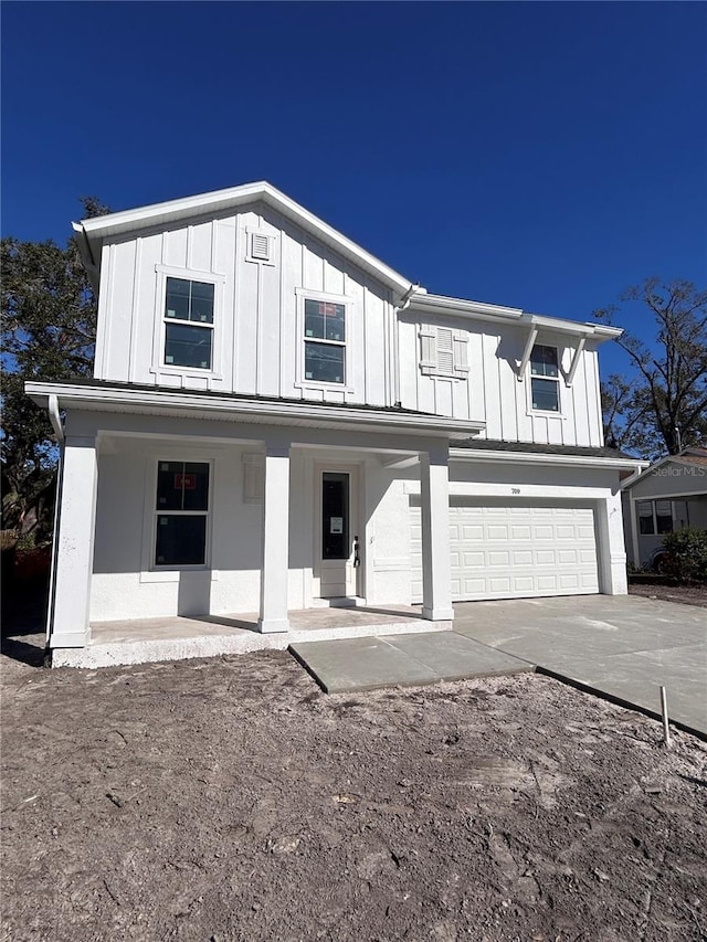 view of front of home with a porch and a garage