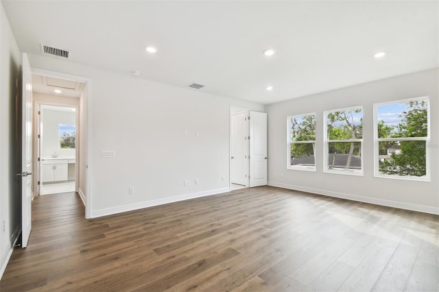 spare room with hardwood / wood-style flooring and a wealth of natural light