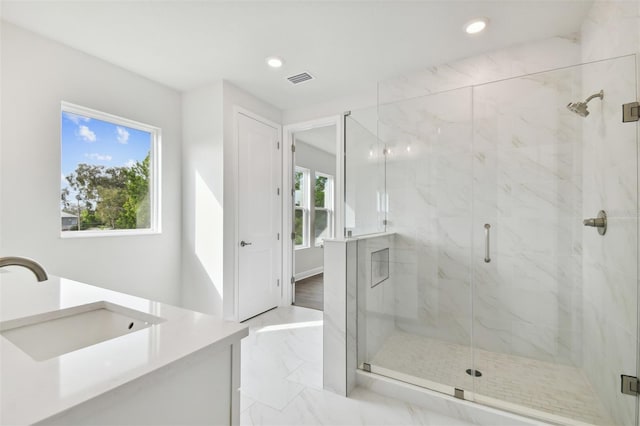 bathroom with vanity and a shower with shower door