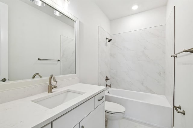 full bathroom featuring tiled shower / bath combo, vanity, and toilet