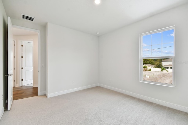 unfurnished room featuring light colored carpet