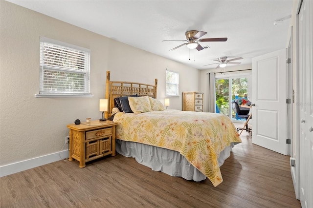 bedroom with access to exterior, dark hardwood / wood-style flooring, a closet, and ceiling fan