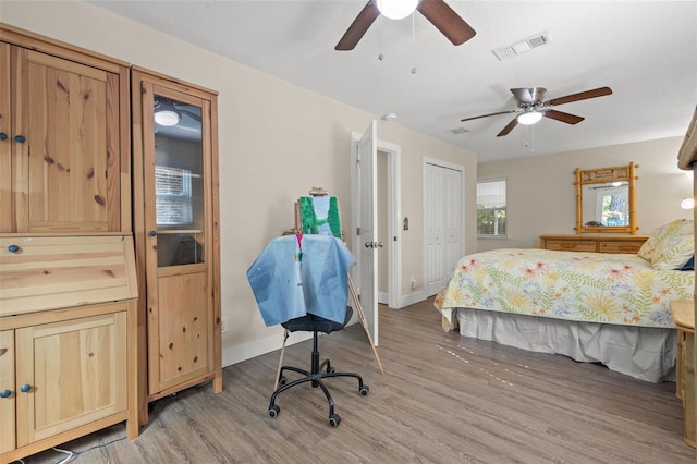 bedroom with ceiling fan, a closet, and light wood-type flooring