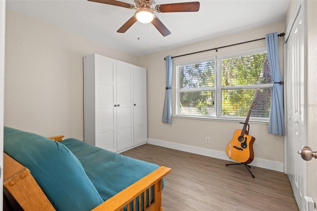 bedroom with ceiling fan and wood-type flooring