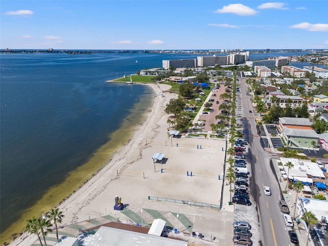 drone / aerial view with a water view and a beach view