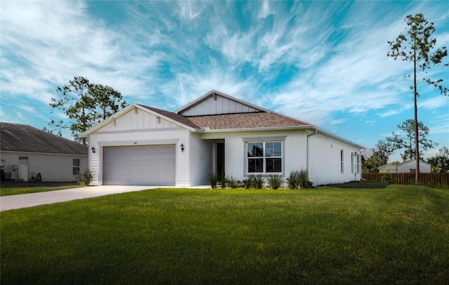 view of front of property with a garage and a front lawn