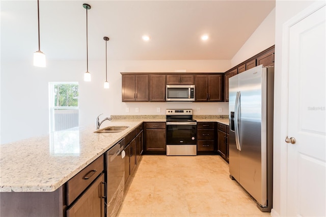 kitchen with light stone countertops, stainless steel appliances, vaulted ceiling, sink, and pendant lighting