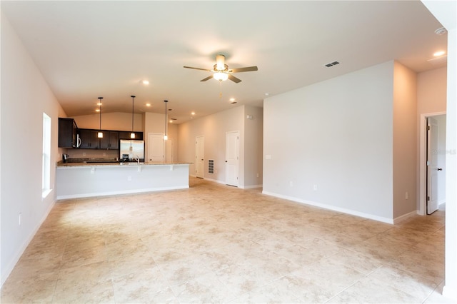 unfurnished living room featuring ceiling fan and vaulted ceiling