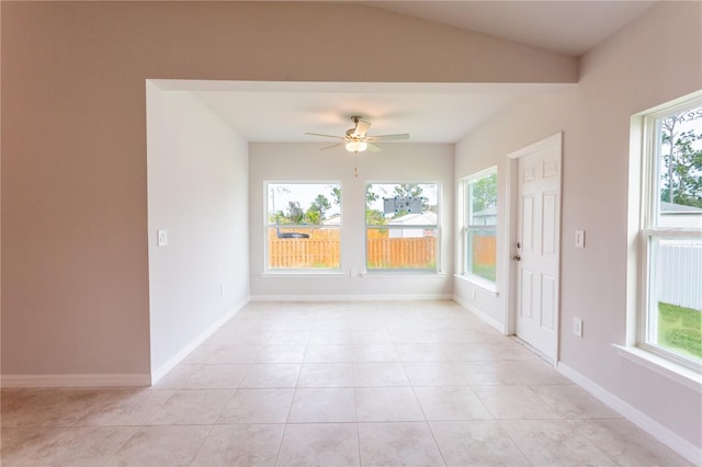 tiled spare room featuring vaulted ceiling, plenty of natural light, and ceiling fan