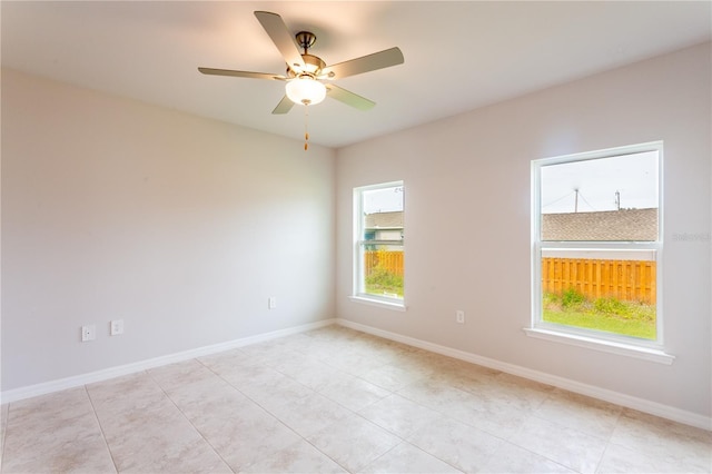 unfurnished room featuring ceiling fan and light tile patterned floors