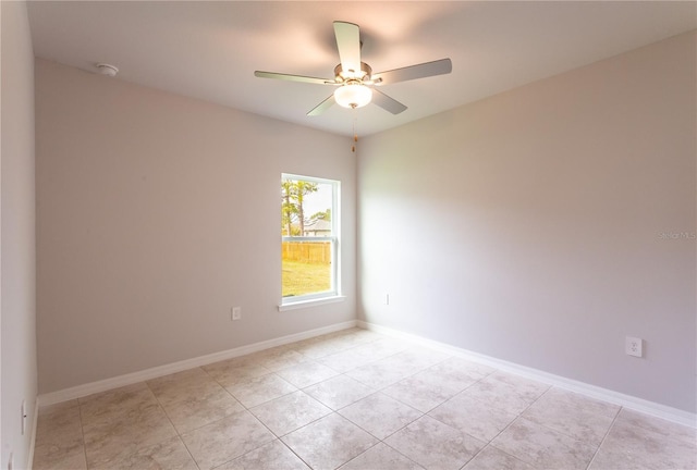 spare room featuring light tile patterned floors and ceiling fan