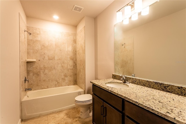 full bathroom featuring toilet, vanity, and tiled shower / bath