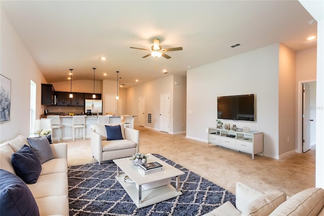 tiled living room with ceiling fan and vaulted ceiling