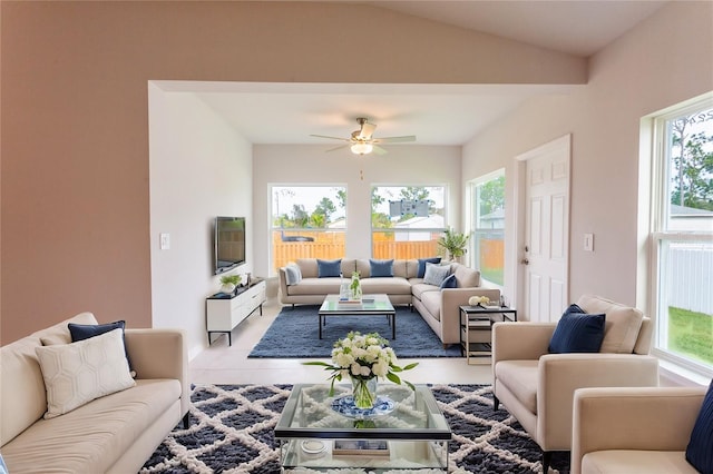 tiled living room with ceiling fan and lofted ceiling