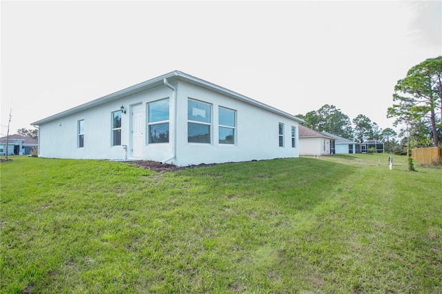 view of side of property featuring a yard