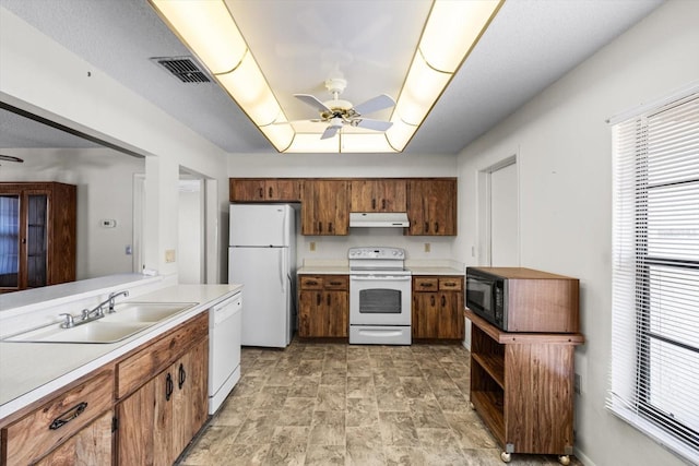 kitchen with ceiling fan, sink, and white appliances