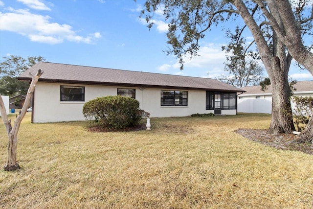 view of front facade featuring a sunroom and a front yard