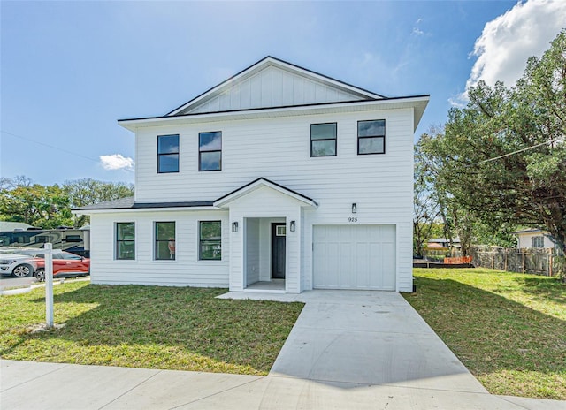 view of front of home with concrete driveway, an attached garage, fence, board and batten siding, and a front yard